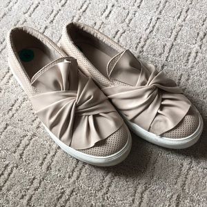 Tan bow slip ons.